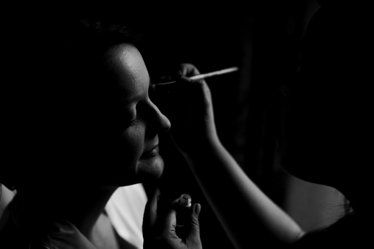 bride getting eye shadow put on 