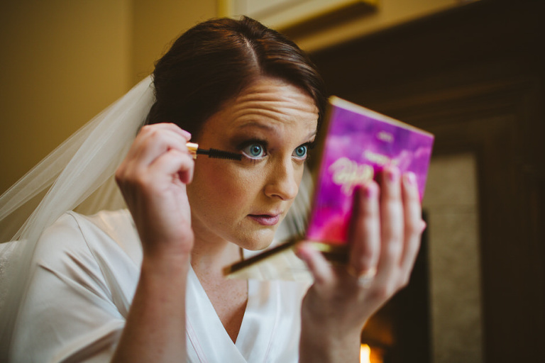 bride putting on mascara