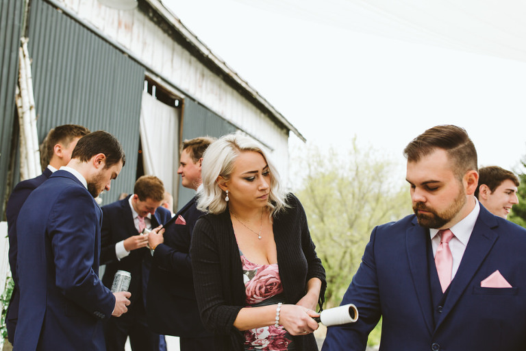 girl lint rolling blue suit jacket 