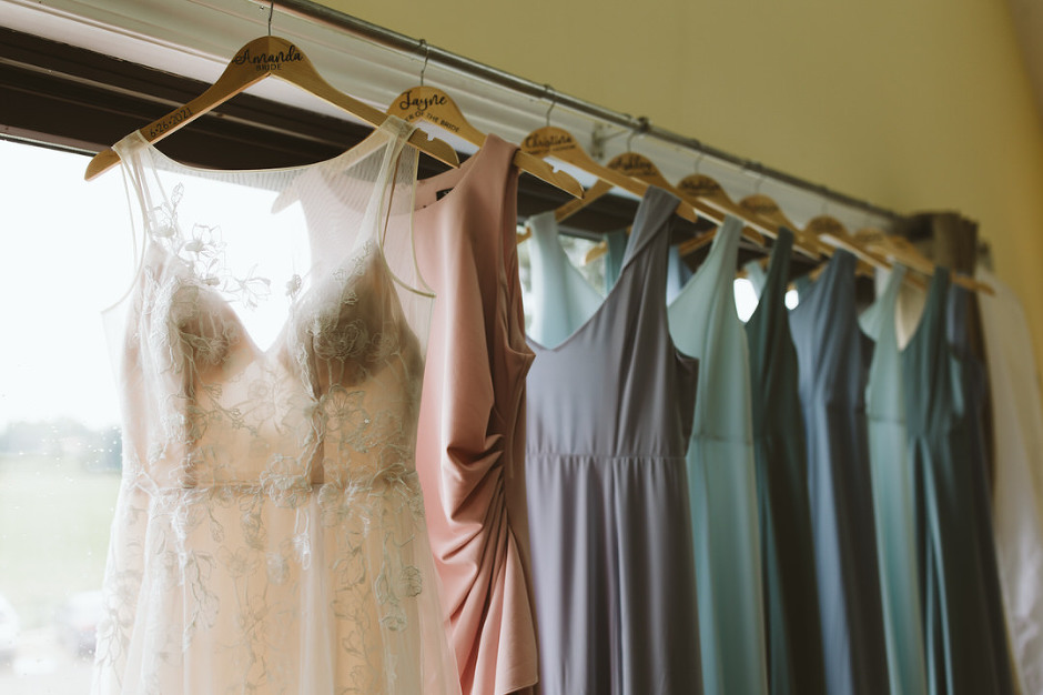brides dress with bridesmaids dresses in a row