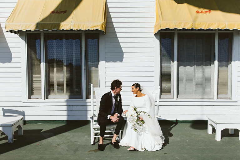 wedding couple on the rocking chairs on the porch of the Grand Hotel on Mackinac Island