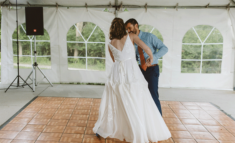 Couple dancing to bluegrass at forest wedding reception